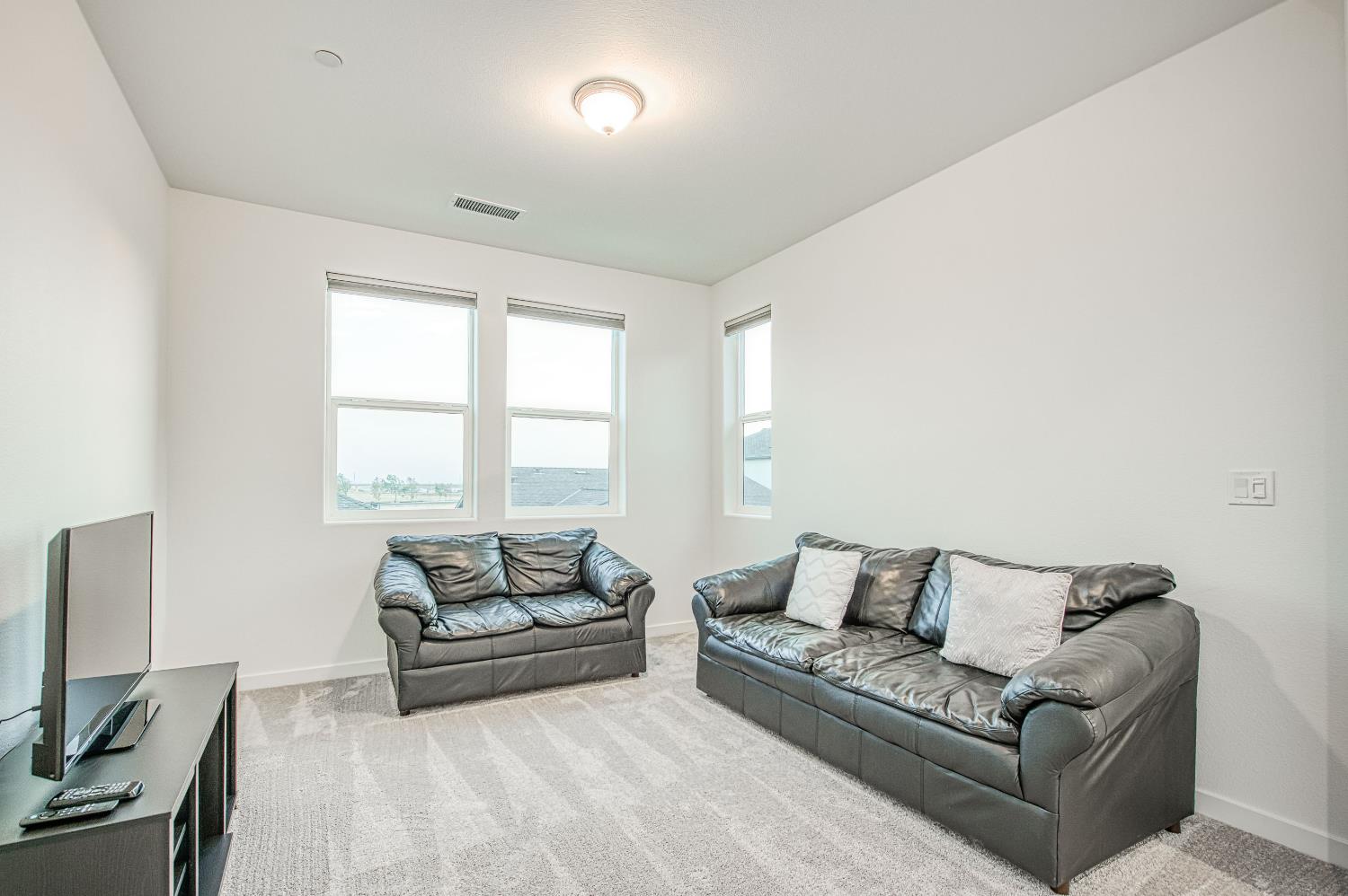 849 Livio Way Madera, CA 93636 - Photo 32 of 74 a living room with furniture and a large window