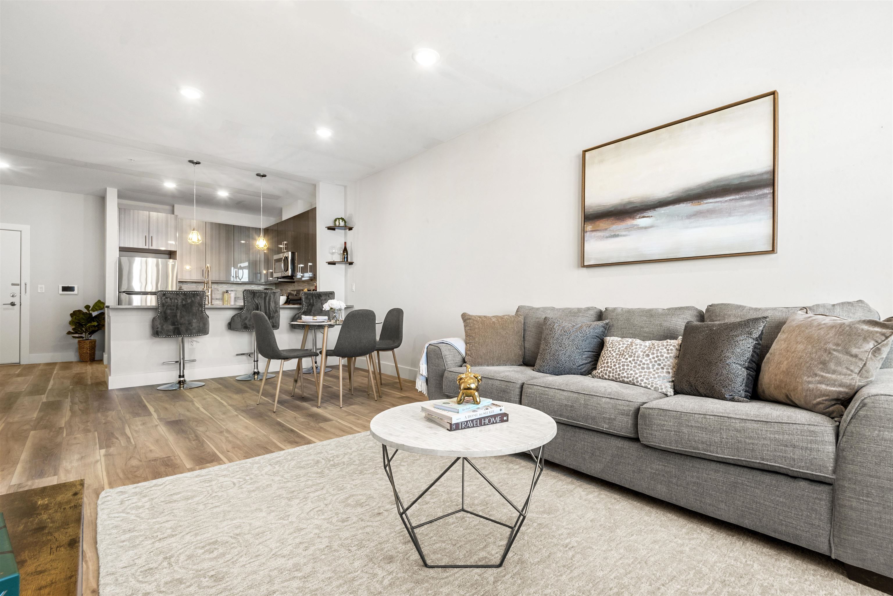 a living room with furniture and kitchen view