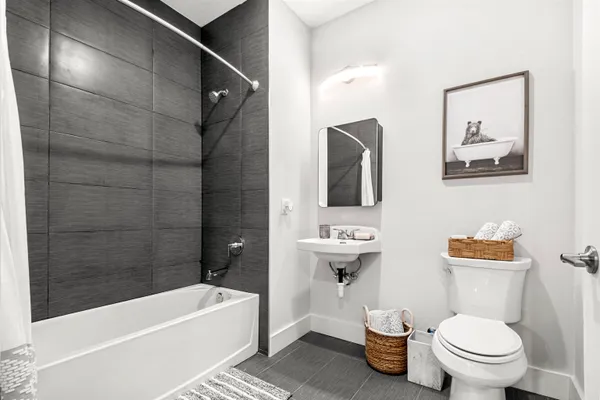 a bathroom with a toilet a sink and bathtub
