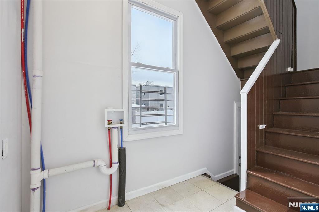 750 South 17th Street Newark, NJ 07103 - Photo 15 of 25 a view of hallway with stairs and wooden floor