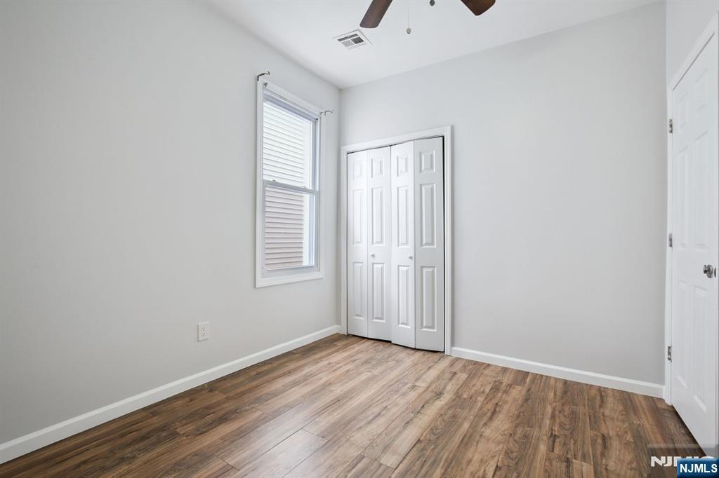 750 South 17th Street Newark, NJ 07103 - Photo 19 of 25 an empty room with wooden floor and windows