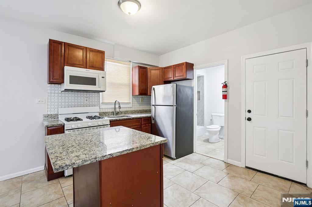 750 South 17th Street Newark, NJ 07103 - Photo 22 of 25 a kitchen with refrigerator and cabinets