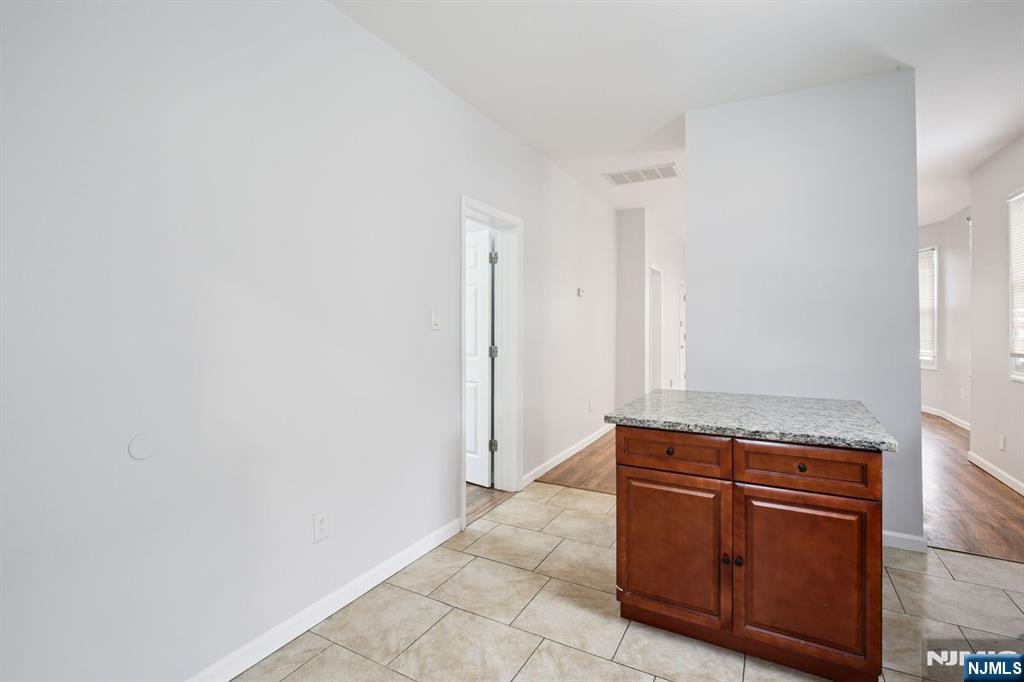 750 South 17th Street Newark, NJ 07103 - Photo 23 of 25 a room with cabinets and wooden floor