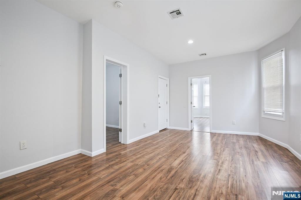 750 South 17th Street Newark, NJ 07103 - Photo 3 of 25 a view of an empty room with wooden floor and window