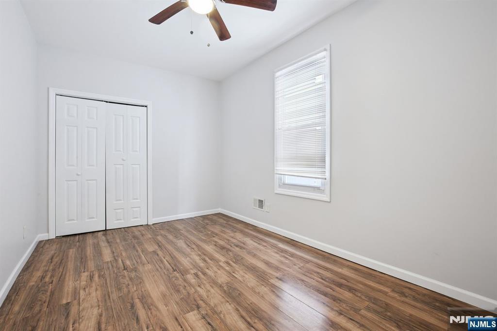 750 South 17th Street Newark, NJ 07103 - Photo 8 of 25 an empty room with a hardwood and ceiling fan