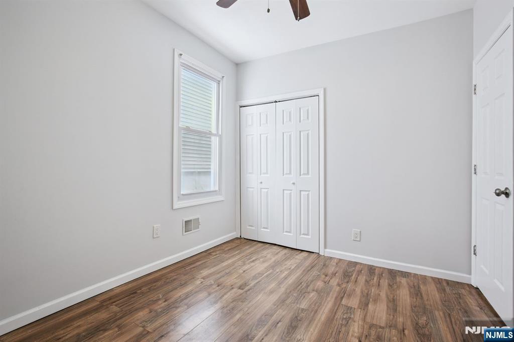 750 South 17th Street Newark, NJ 07103 - Photo 10 of 25 a view of an empty room with wooden floor and a window