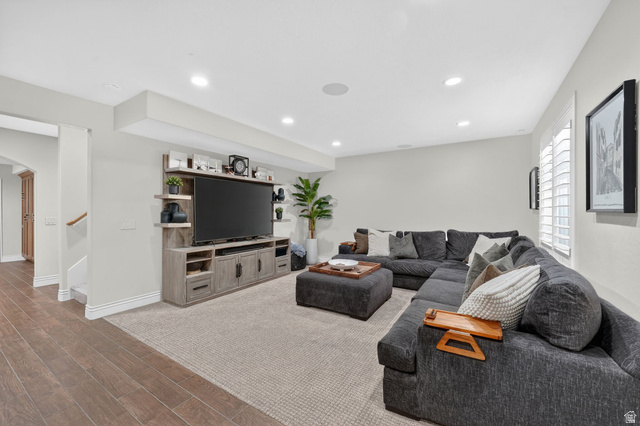 14738 Tangle Hill Road Herriman, UT 84096 - Photo 39 of 66 Entertainment area featuring wood-finish flooring, recessed lighting, and a built-in media console with open shelving