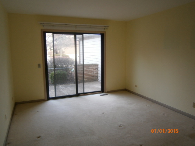 N686 Chelsea Circle Winfield, IL 60190 - Photo 13 of 25 a view of an empty room with a sliding door