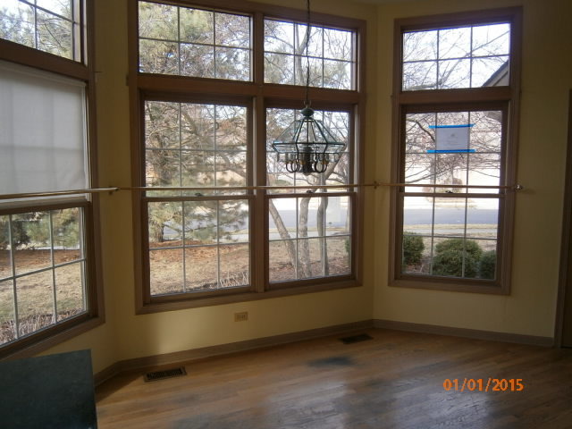 N686 Chelsea Circle Winfield, IL 60190 - Photo 5 of 25 an empty room with wooden floor and windows