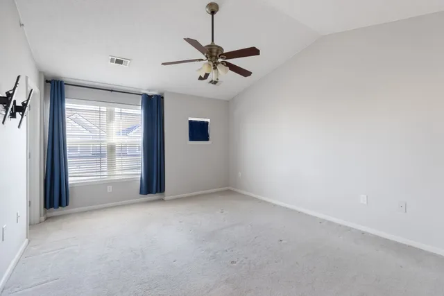 a view of a livingroom with a ceiling fan and window