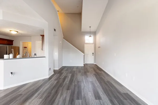 a view of a hallway with wooden floor and staircase