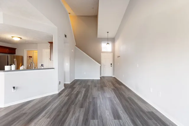 a view of a hallway with wooden floor and staircase