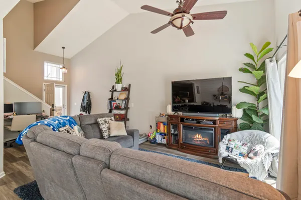 a living room with furniture a flat screen tv and a fireplace