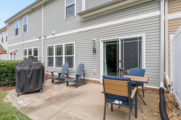 a view of a two chairs in the back yard