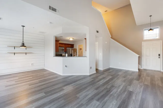 a view of a room with wooden floor and stairs