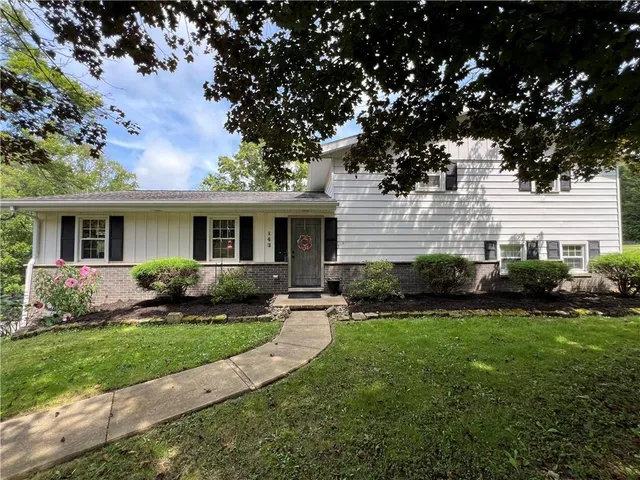 a front view of a house with a yard and porch