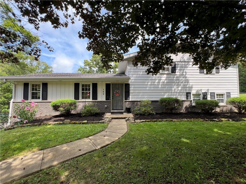 a front view of a house with a yard and porch