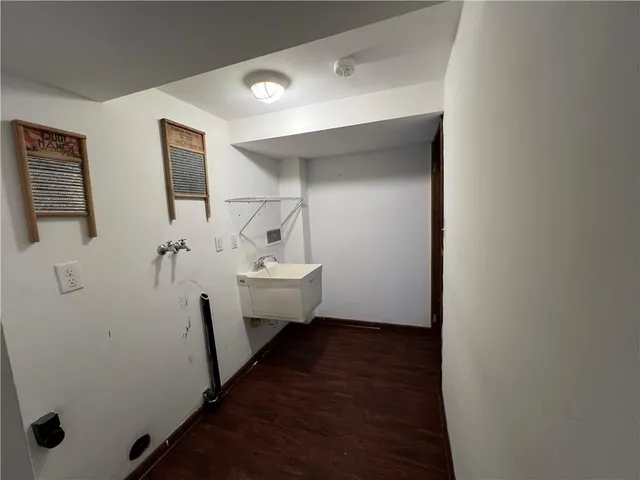 a bathroom with a sink a toilet a mirror and shower