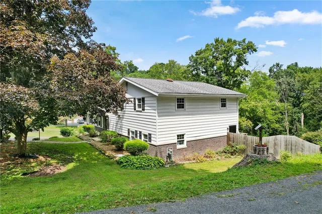 a front view of a house with a garden