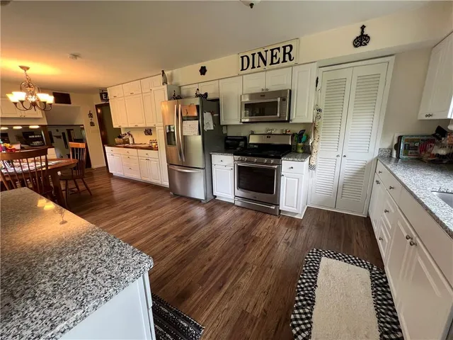 a kitchen with stainless steel appliances and wooden cabinets