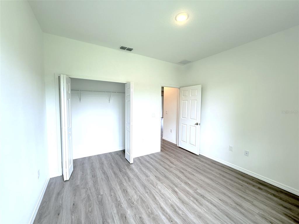 1294 Napoleon Road North Port, FL 34288 - Photo 18 of 25 an empty room with wooden floor and closet