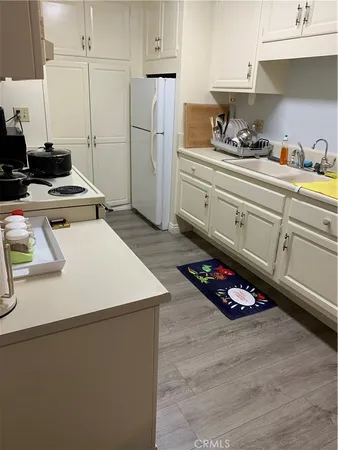 a kitchen with a stove a refrigerator and cabinets