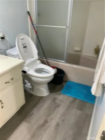 a white toilet sitting next to a bathroom sink