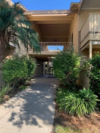 a view of a patio with table and chairs and potted plants
