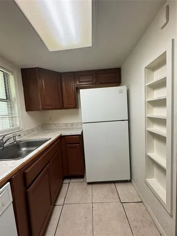 a kitchen with a refrigerator and a sink