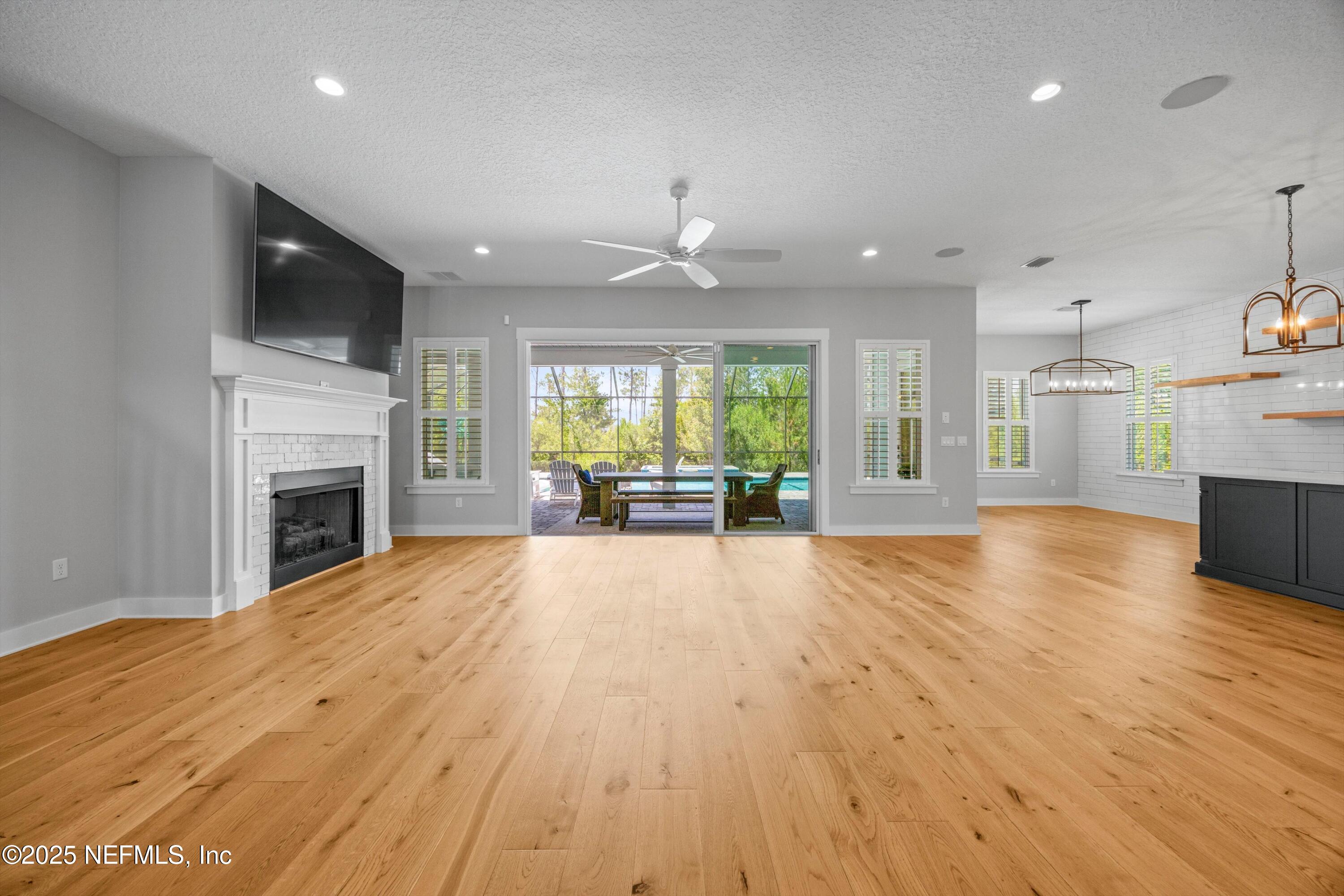 86 Sunset Ridge Court St. Johns, FL 32259 - Photo 12 of 66 a view of an empty room and a kitchen with a fireplace