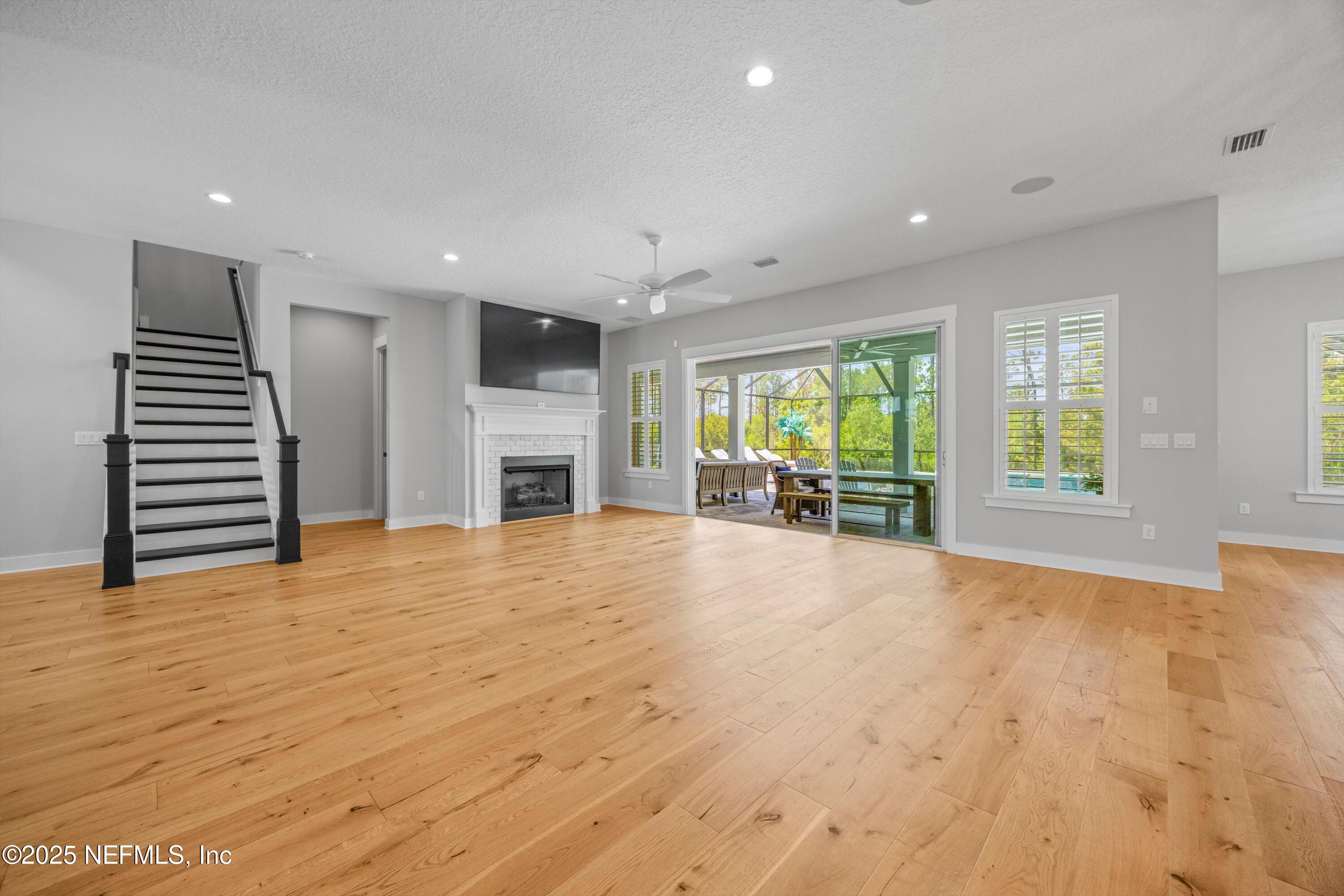 86 Sunset Ridge Court St. Johns, FL 32259 - Photo 13 of 66 a view of an empty room with a fireplace and a window