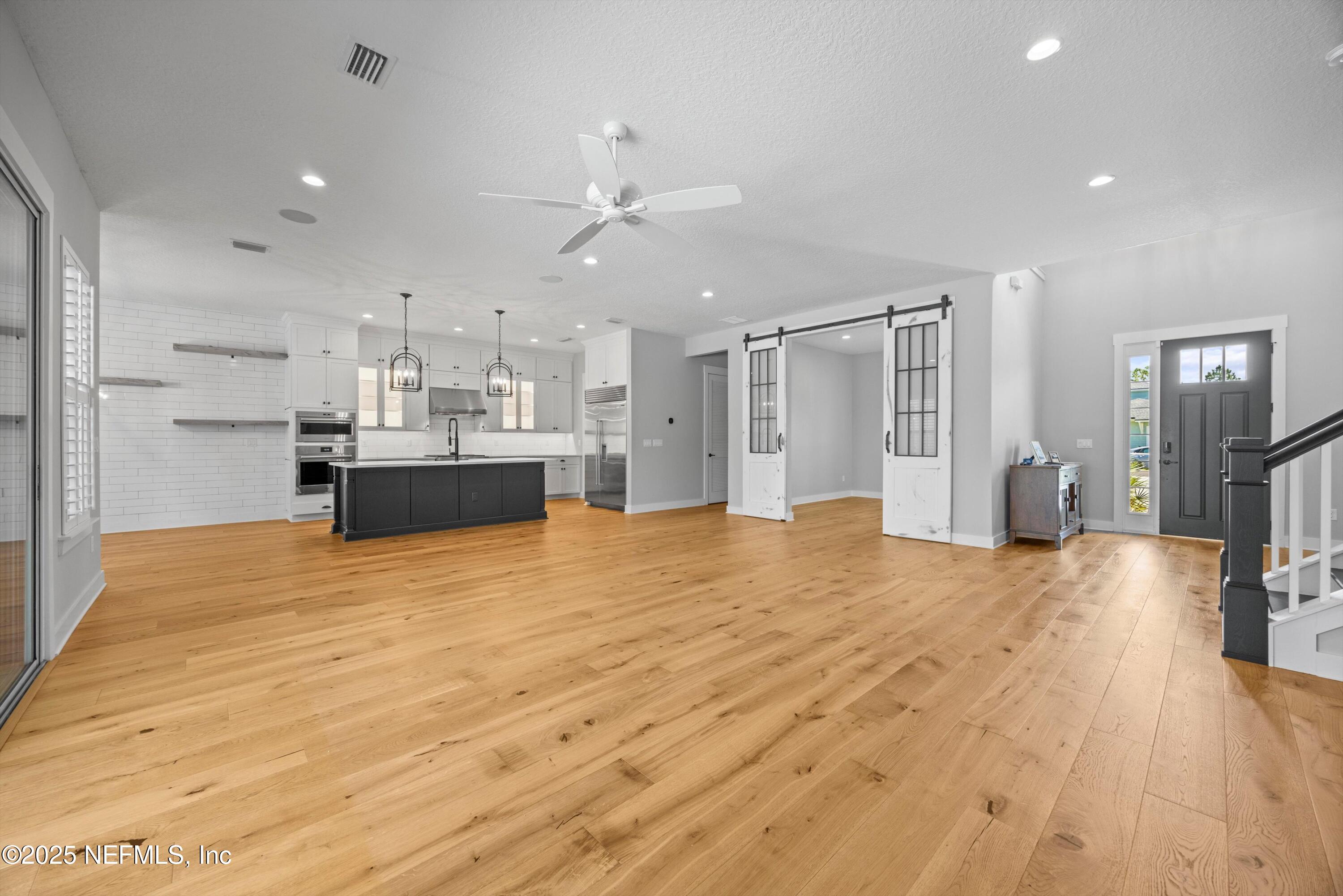 86 Sunset Ridge Court St. Johns, FL 32259 - Photo 14 of 66 a view of a kitchen with kitchen island stainless steel appliances refrigerator stove and wooden floor