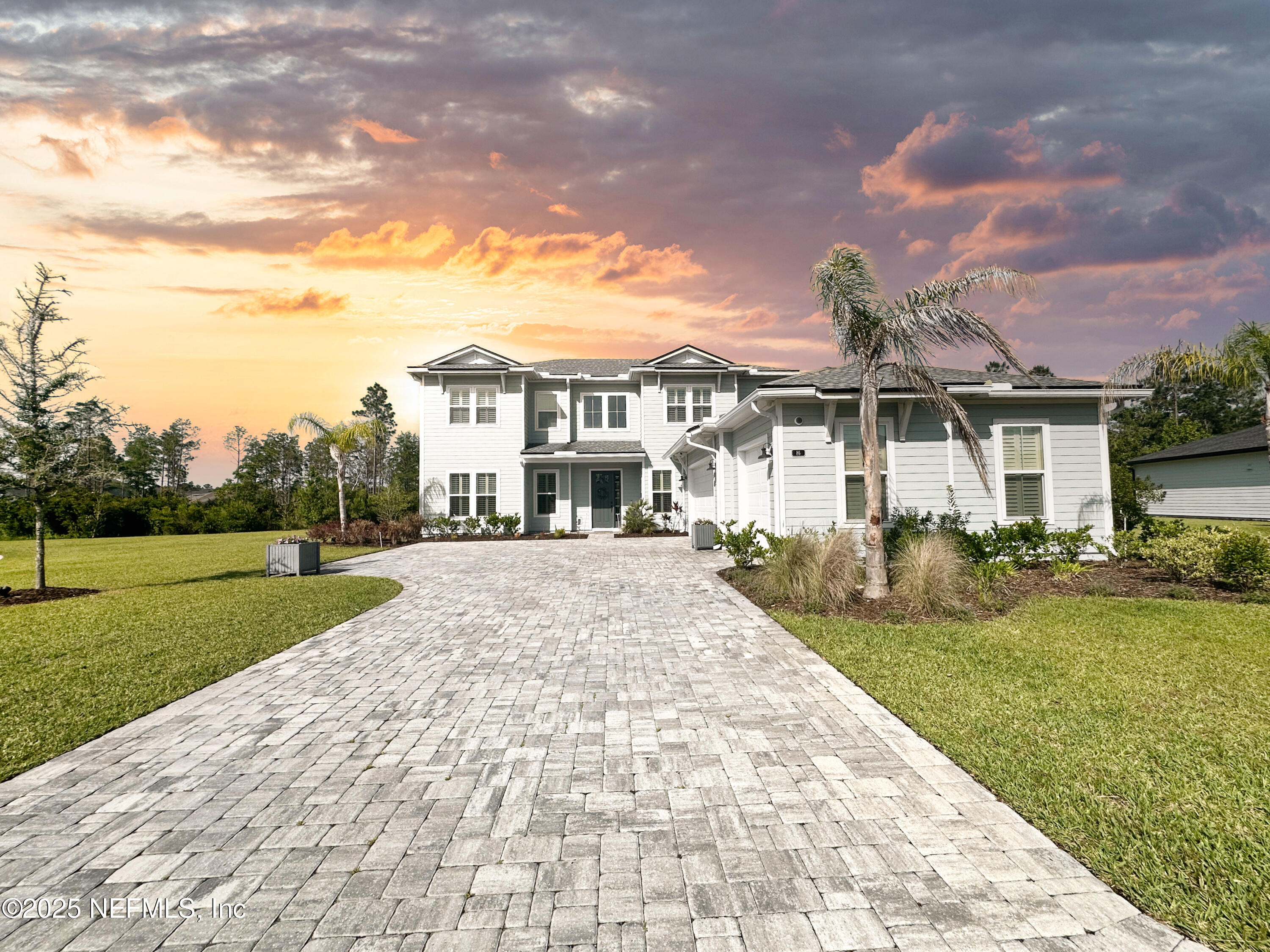 86 Sunset Ridge Court St. Johns, FL 32259 - Photo 2 of 66 a view of a white house in front of a big yard with plants and large trees