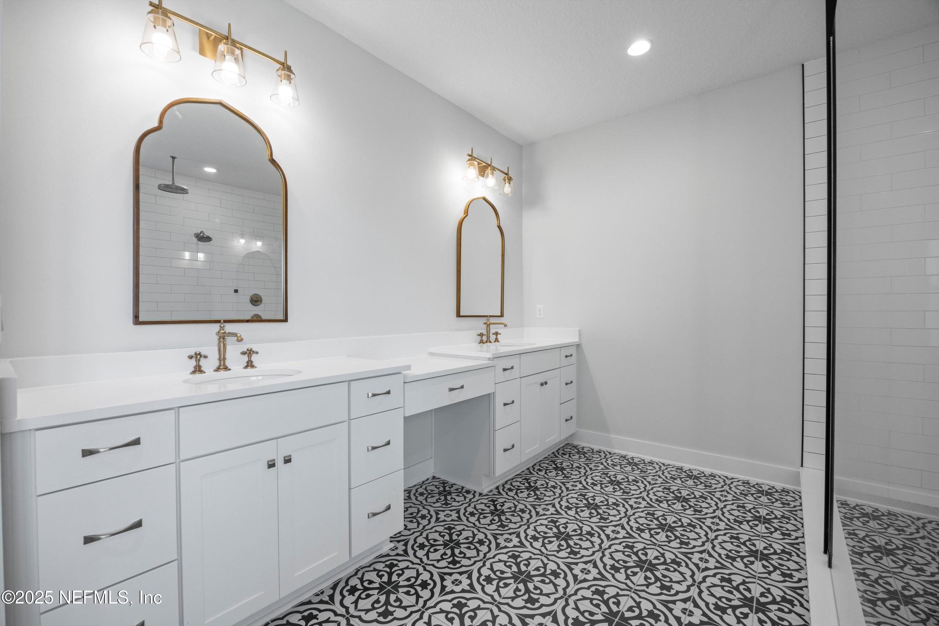 86 Sunset Ridge Court St. Johns, FL 32259 - Photo 29 of 66 a bathroom with a double vanity sink and mirror