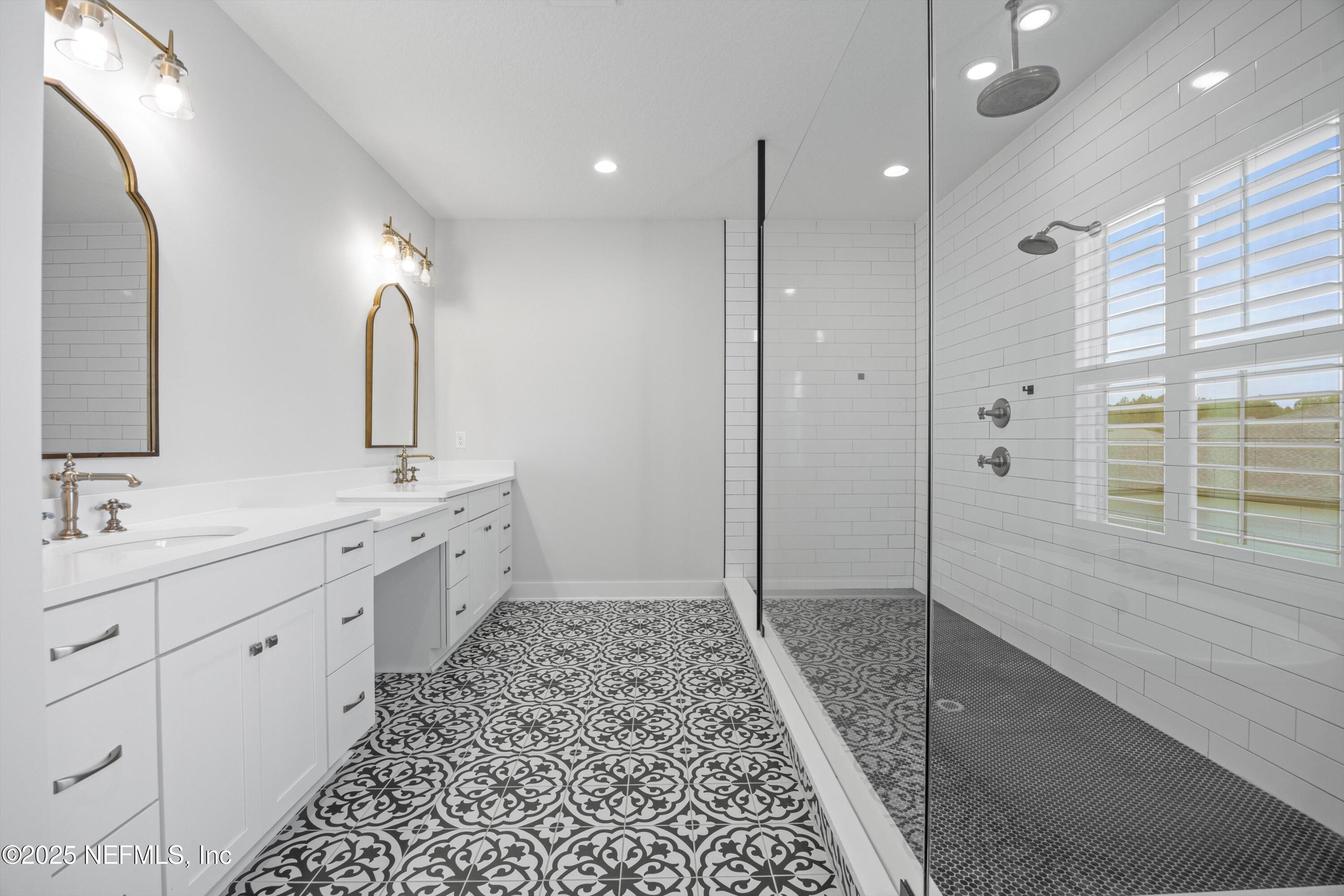 86 Sunset Ridge Court St. Johns, FL 32259 - Photo 30 of 66 a bathroom with a double vanity sink a toilet and a shower