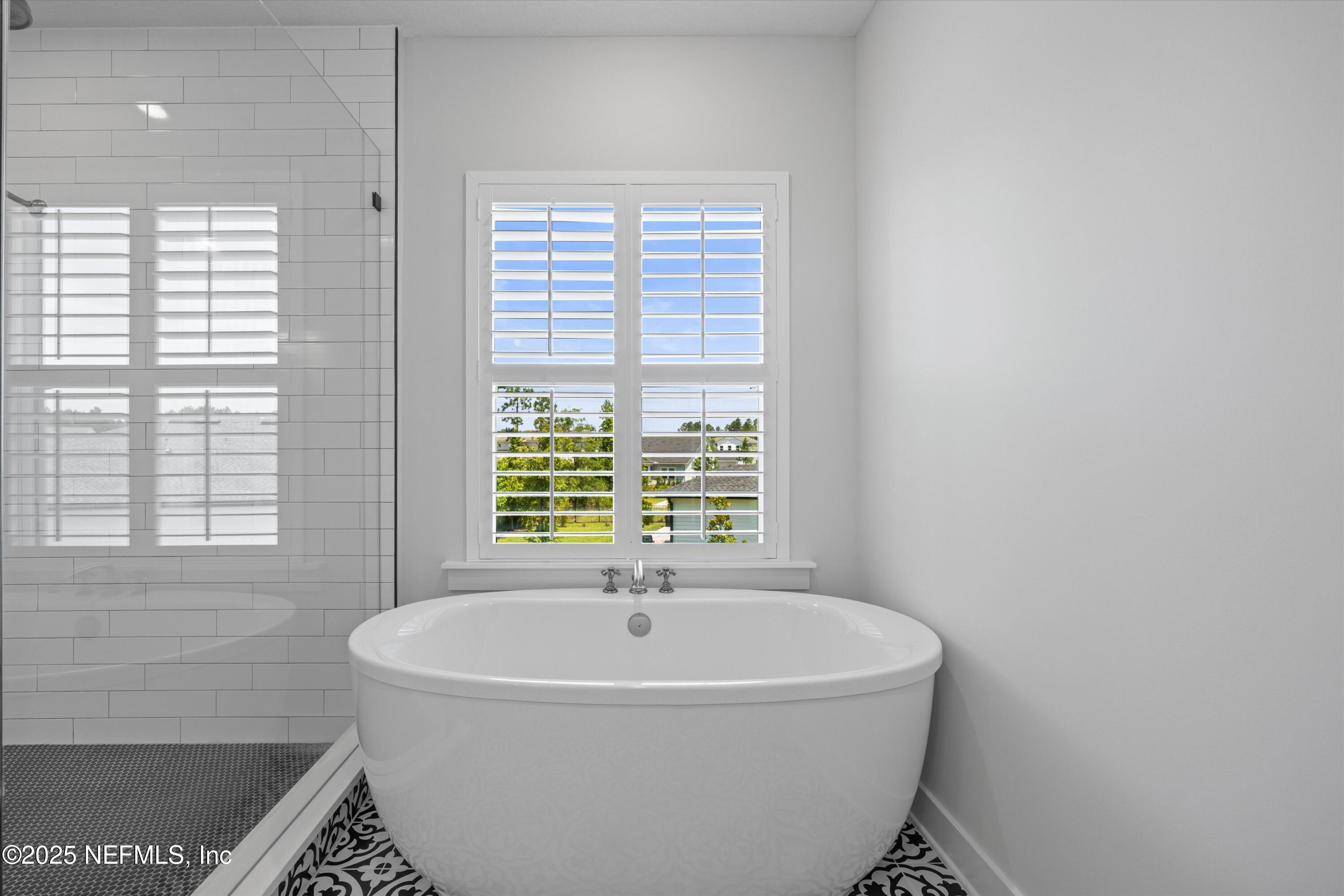 86 Sunset Ridge Court St. Johns, FL 32259 - Photo 31 of 66 a white bath tub sitting in a bathroom next to a window