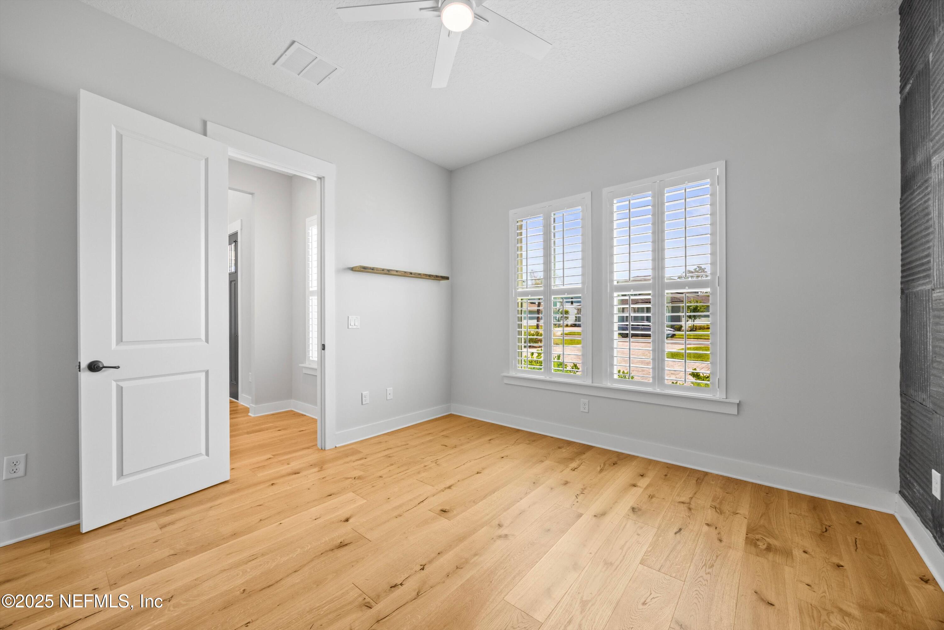 86 Sunset Ridge Court St. Johns, FL 32259 - Photo 37 of 66 a view of empty room with wooden floor and fan
