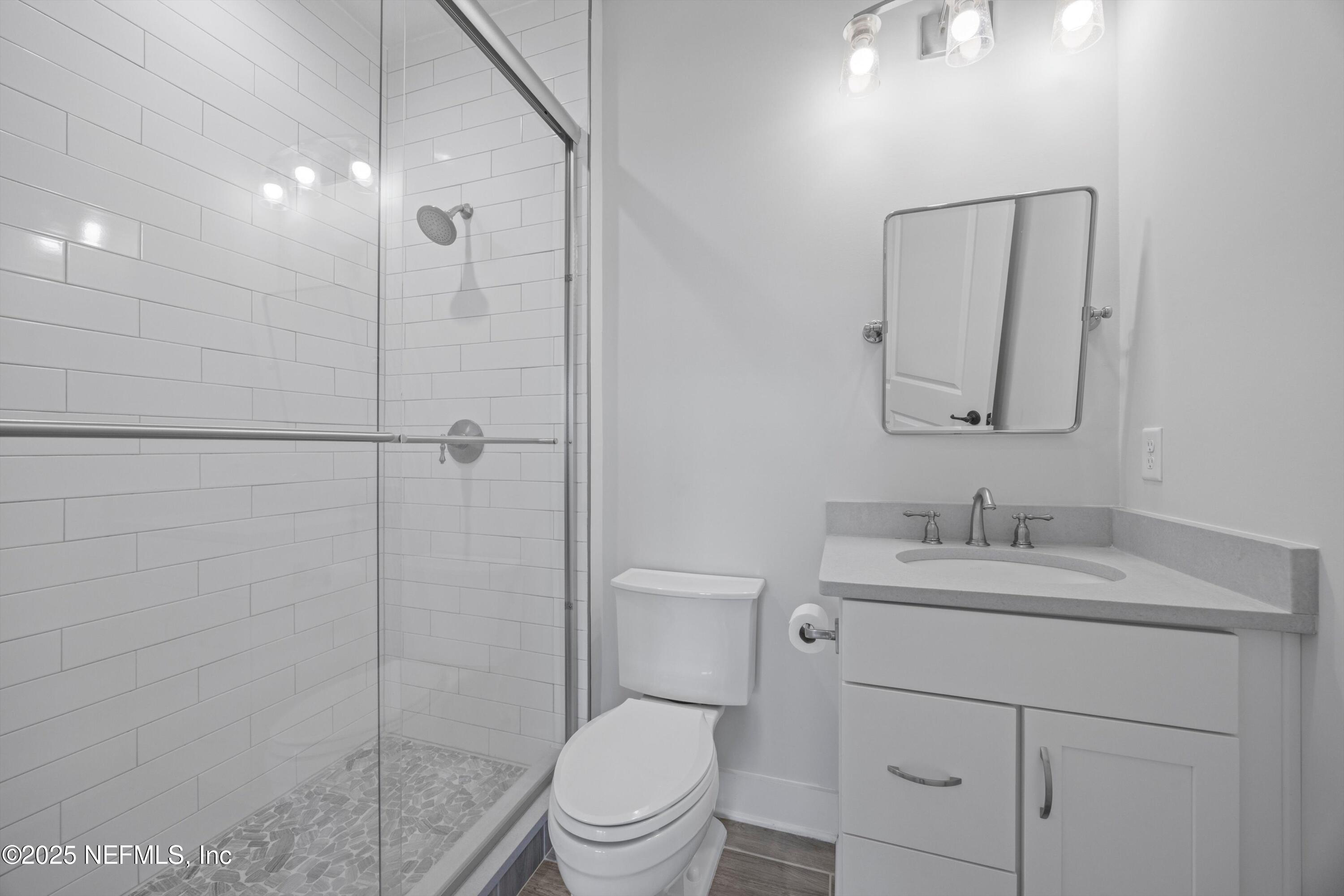 86 Sunset Ridge Court St. Johns, FL 32259 - Photo 38 of 66 a bathroom with a toilet sink vanity and mirror