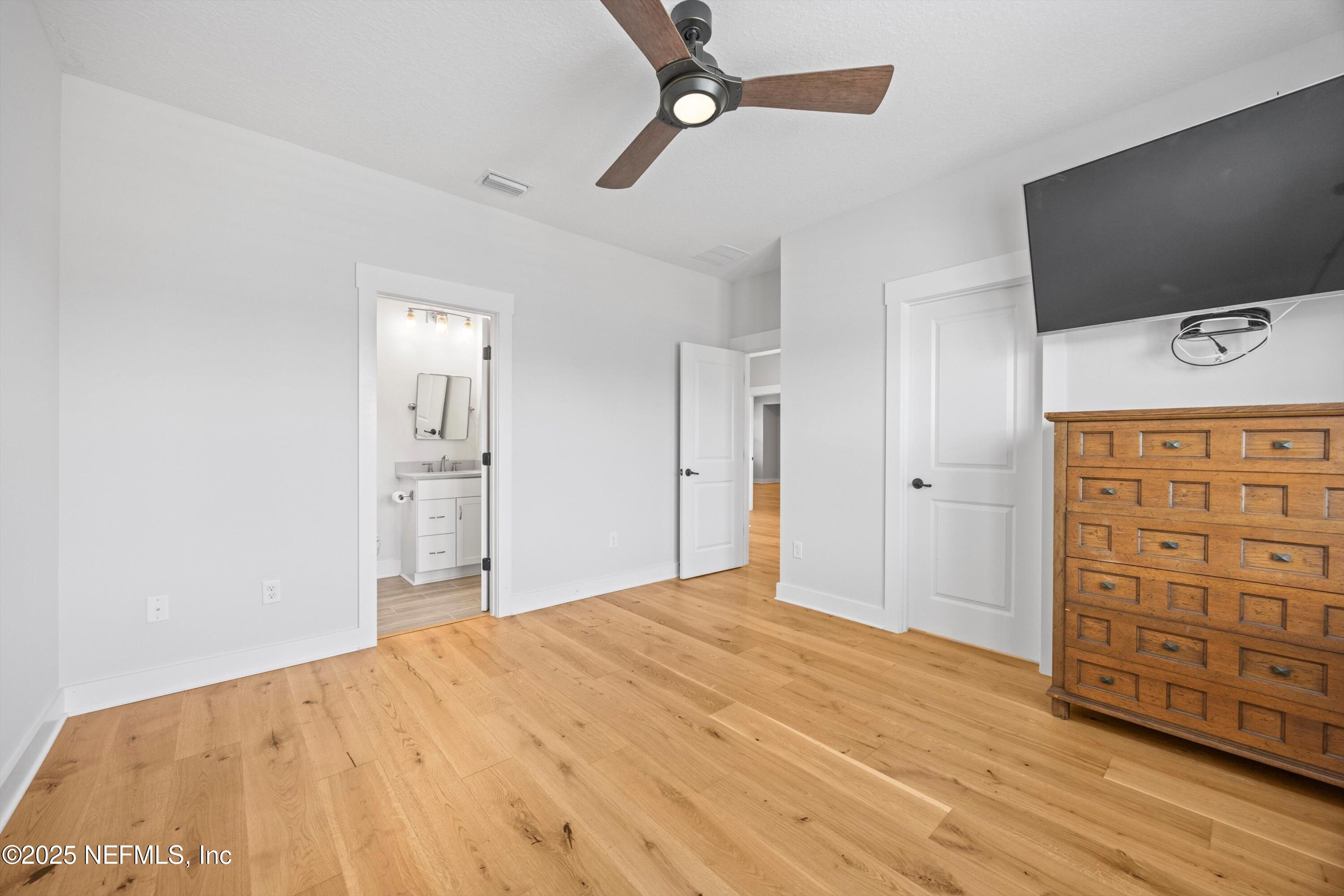 86 Sunset Ridge Court St. Johns, FL 32259 - Photo 50 of 66 a view of a bedroom with cabinet flat screen tv and closet