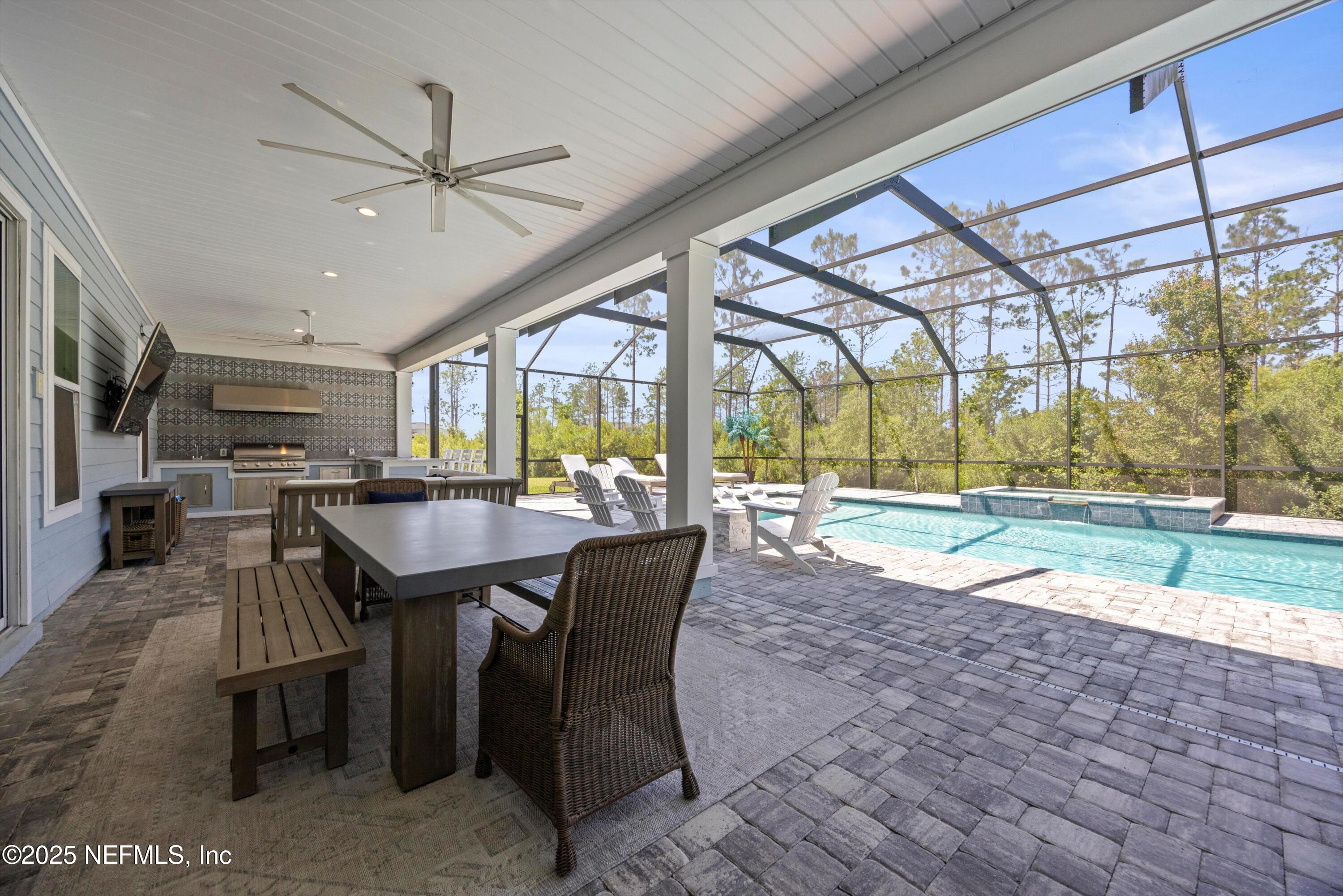 86 Sunset Ridge Court St. Johns, FL 32259 - Photo 55 of 66 a dining room with stainless steel appliances granite countertop a table chairs and a view of living room