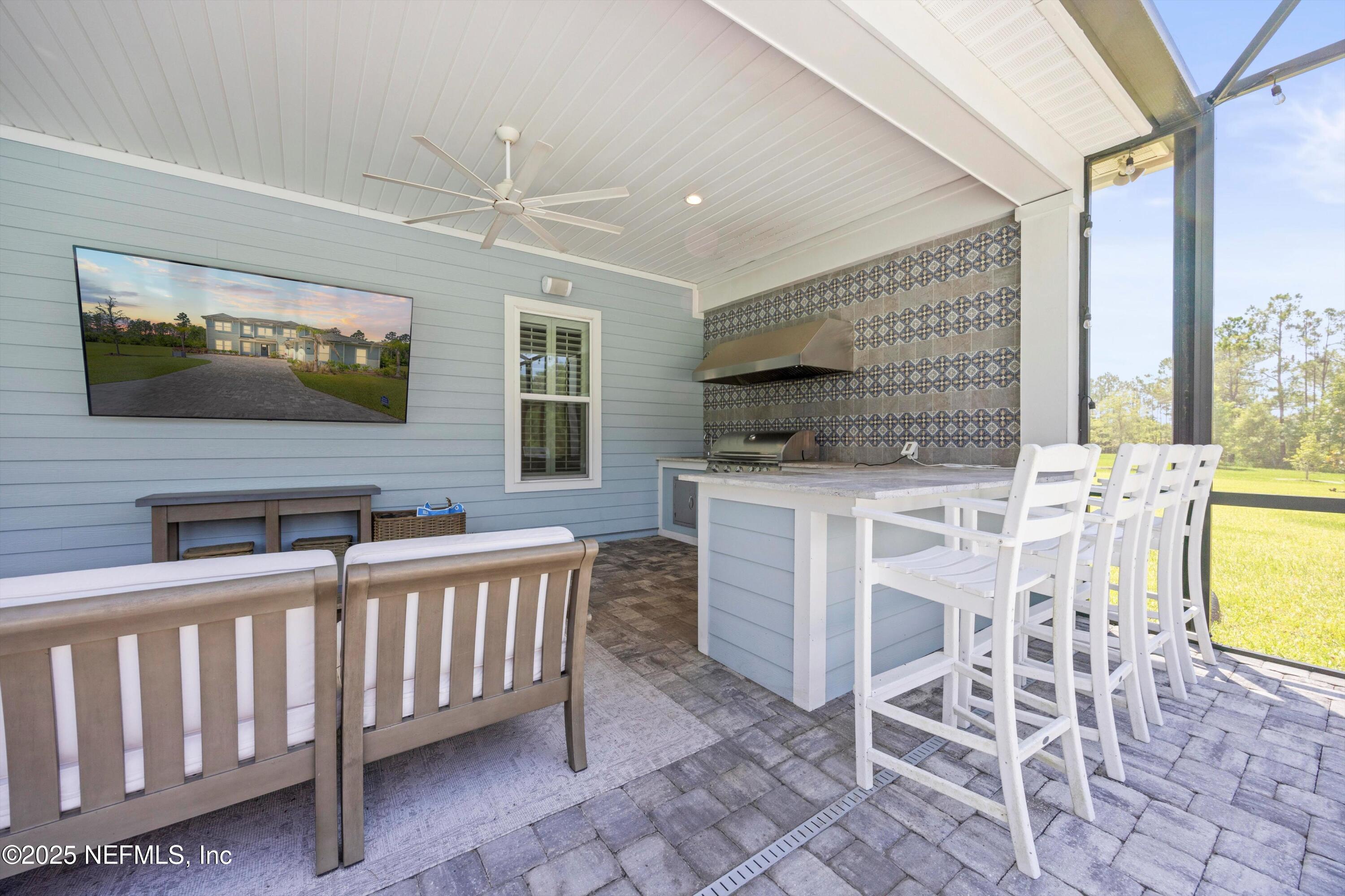 86 Sunset Ridge Court St. Johns, FL 32259 - Photo 61 of 66 a dining room with furniture a flat screen tv and a fireplace