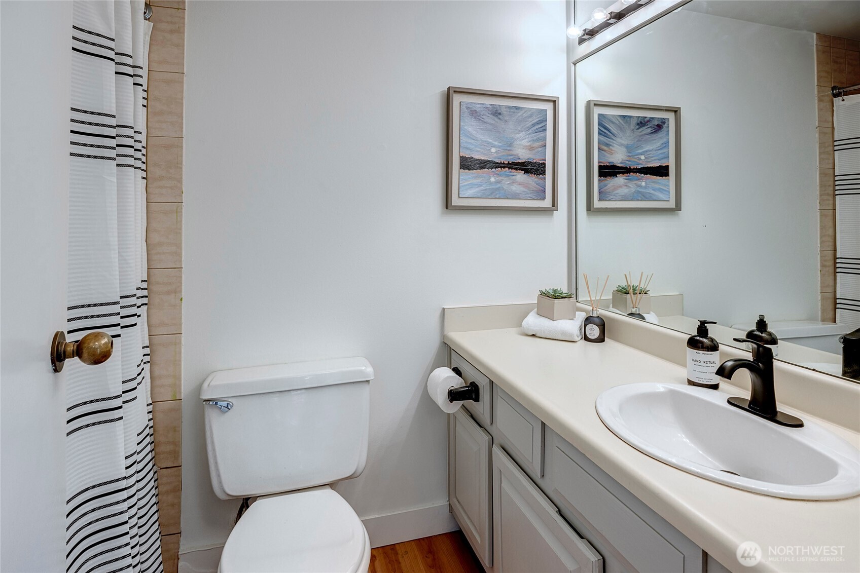 2201 3rd Avenue, Unit 803 Seattle, WA 98121 - Photo 13 of 26 a bathroom with a toilet a sink and mirror