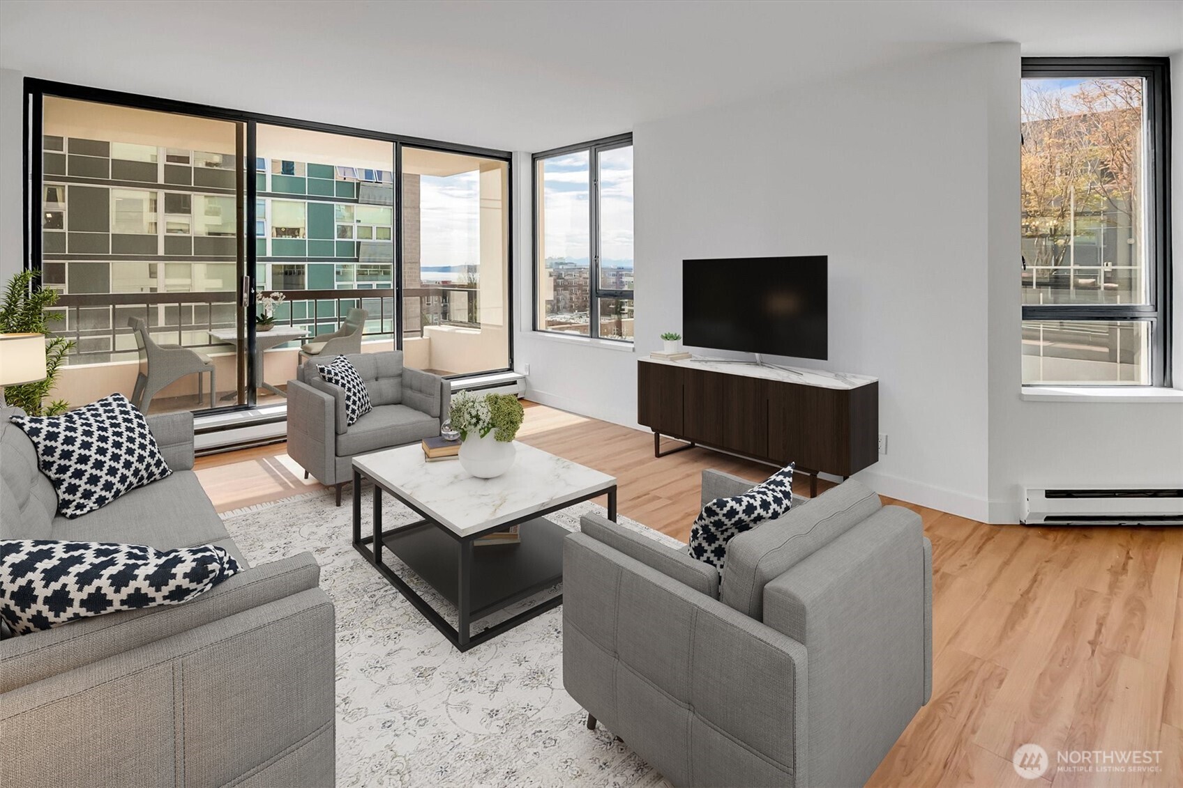 2201 3rd Avenue, Unit 803 Seattle, WA 98121 - Photo 2 of 26 a living room with furniture and a flat screen tv