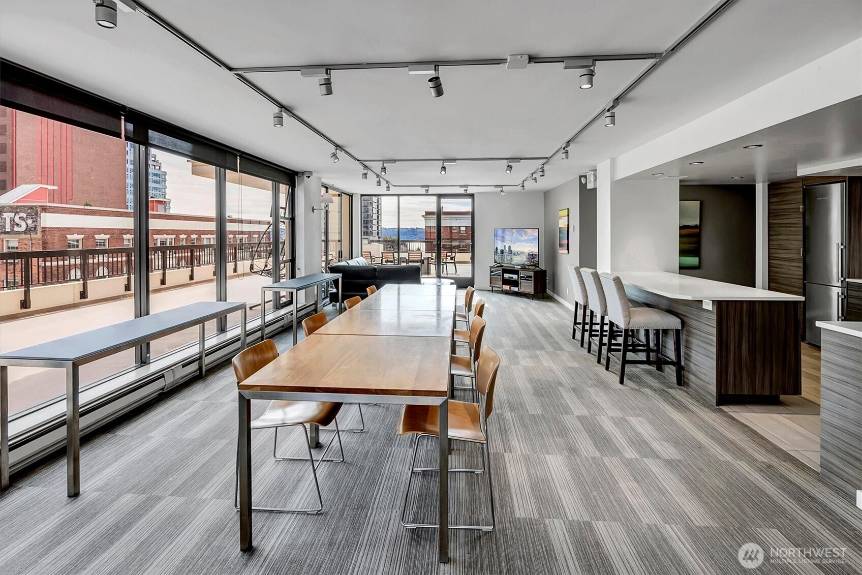 2201 3rd Avenue, Unit 803 Seattle, WA 98121 - Photo 21 of 26 a dining room with wooden floor glass table and chairs