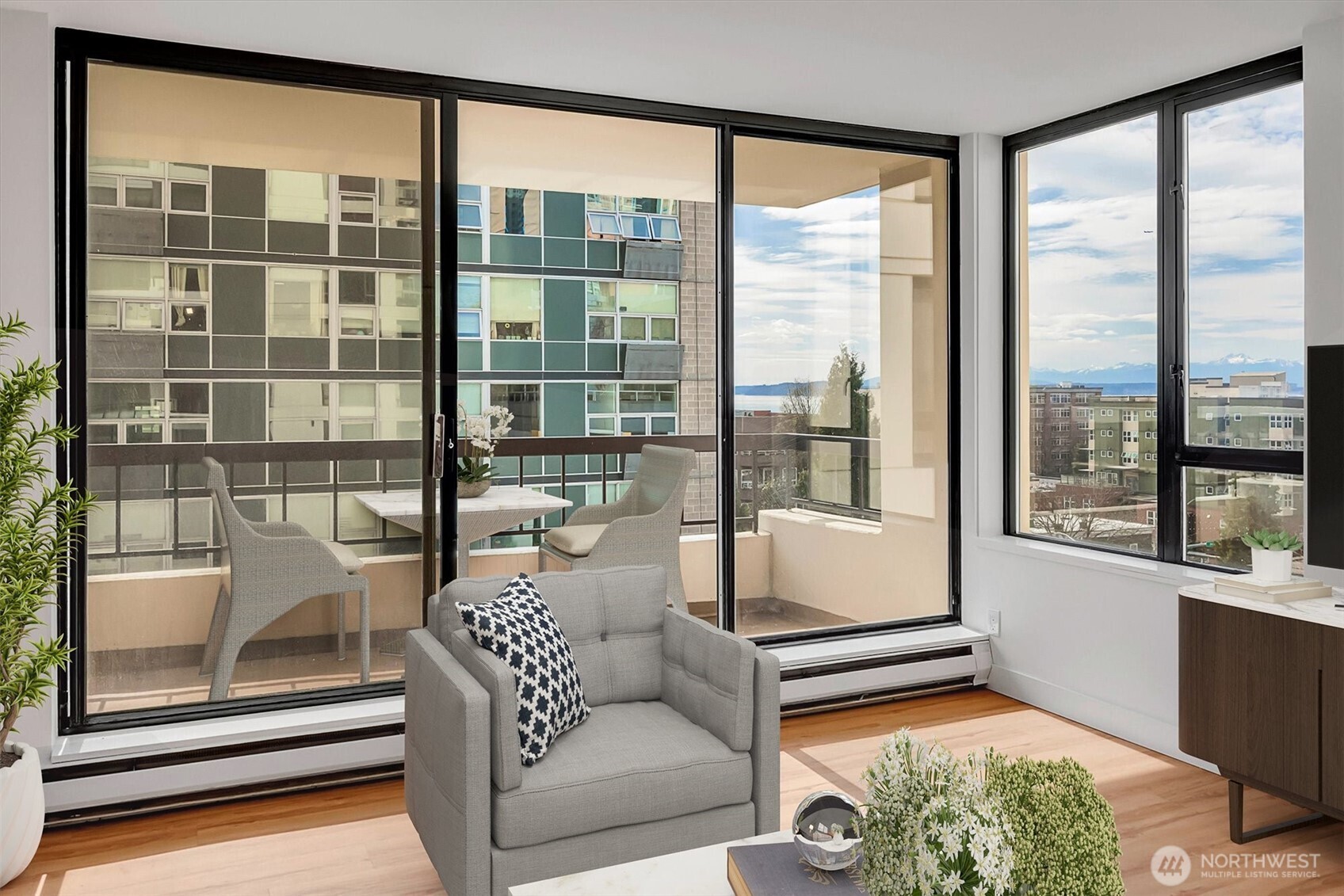 2201 3rd Avenue, Unit 803 Seattle, WA 98121 - Photo 3 of 26 a living room with a large window and a table