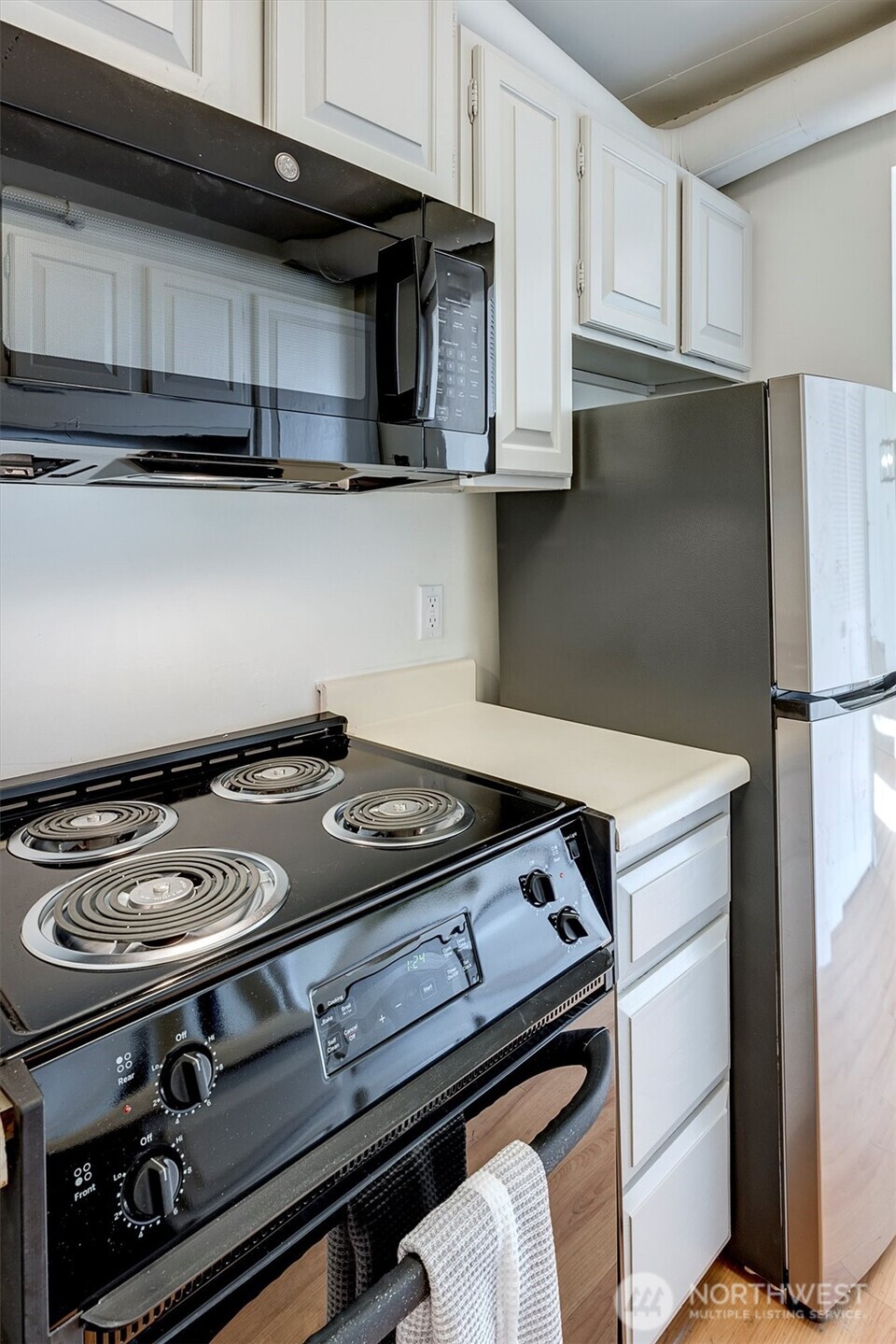 2201 3rd Avenue, Unit 803 Seattle, WA 98121 - Photo 9 of 26 a stove top oven sitting inside of a kitchen