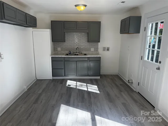 a kitchen with stainless steel appliances a refrigerator and a stove top oven
