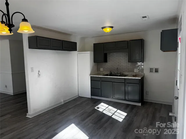 a kitchen with a refrigerator and a stove