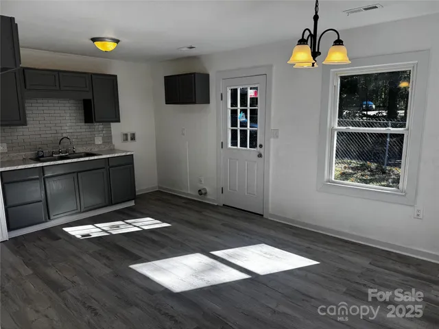 a kitchen with a sink and a stove top oven