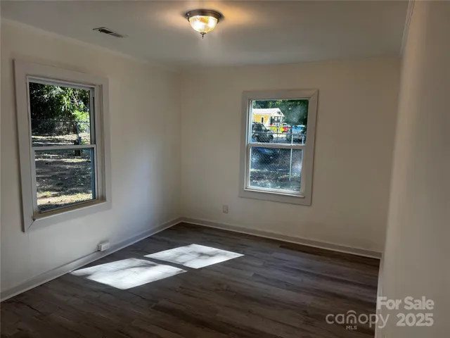 a room with a window and a wooden floor